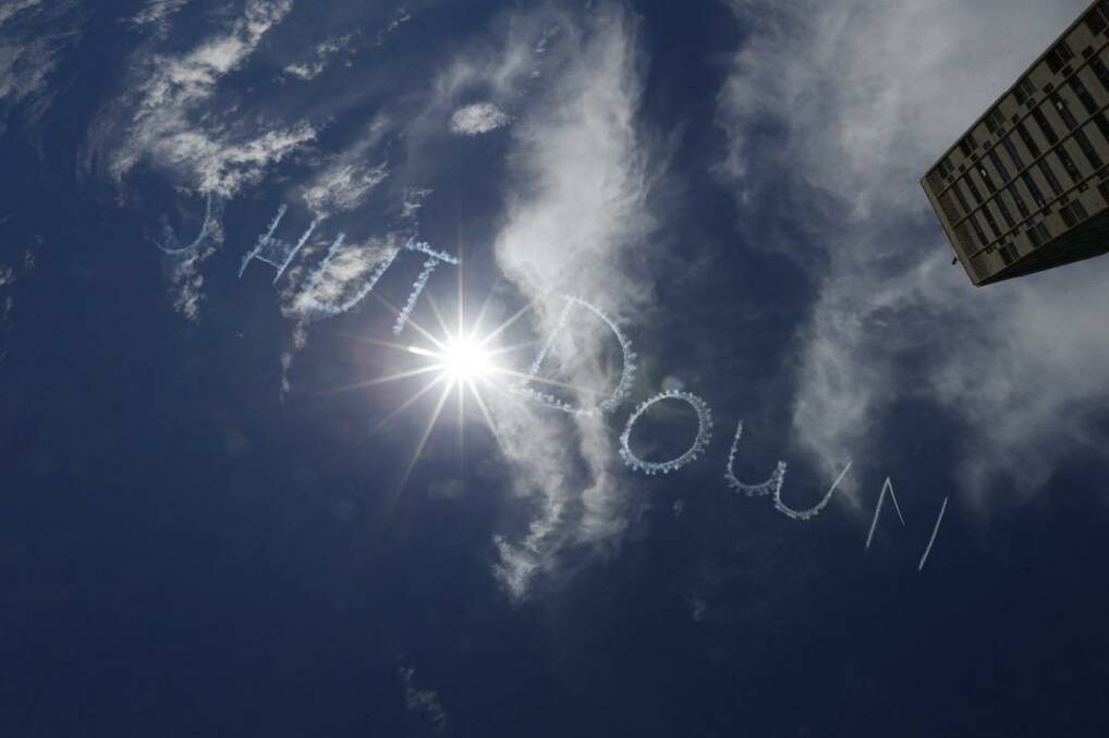 Skywriting over Sydney calling for the Manus Island detention centre to be shut down. Photo: Peter Rae