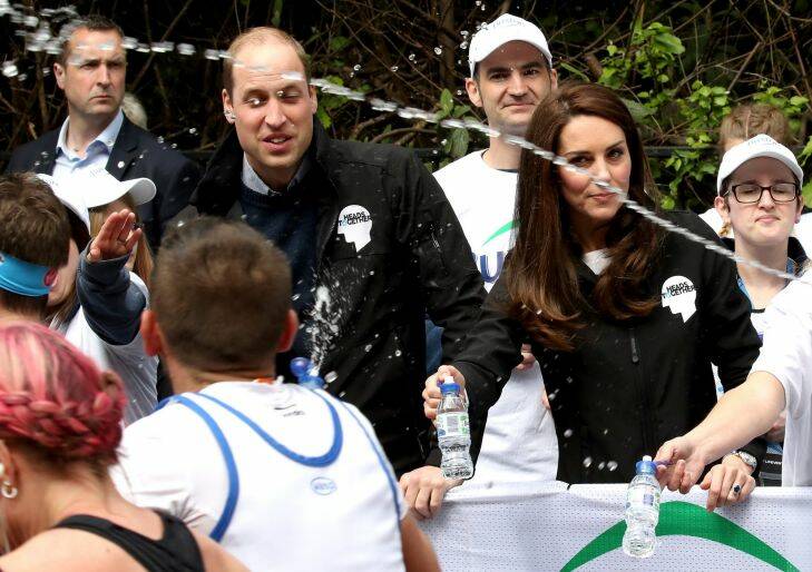 LONDON, ENGLAND - APRIL 23:  A runner squirts water towards Prince William, Duke of Cambridge and Catherine, Duchess of Cambridge as they hand out water to runners during the 2017 Virgin Money London Marathon on April 23, 2017 in London, England. The Duke and Duchess of Cambridge and Prince Harry, are spearheading Heads Together, in partnership with eight leading mental health charities, that are tackling stigma, raising awareness, and providing vital help for people with mental health problems.  (Photo by Chris Jackson - WPA Pool/Getty Images) Photo: Chris Jackson