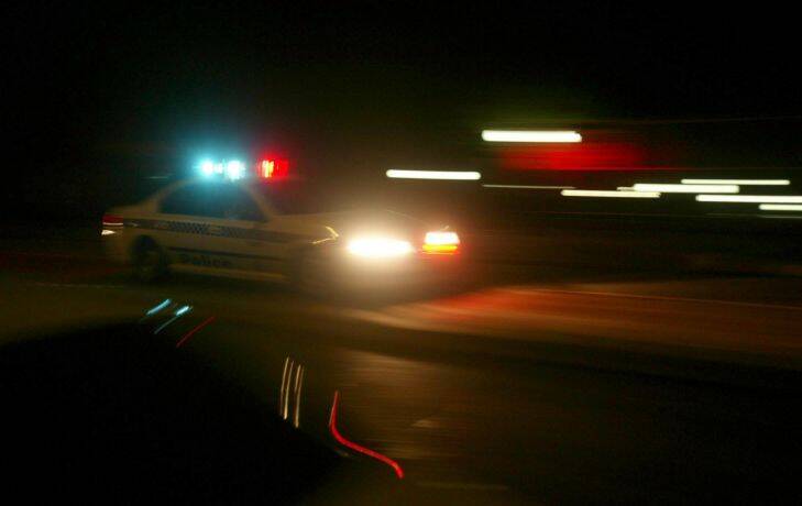 A NSW Police Car, with Siren and lights rushing through Five Dock...Police chasers, Law Enforcement, Emergencies, Save as Generic .. Artpix.. Pix by Quentin Jones..Dec 2005. SPECIALX 010101