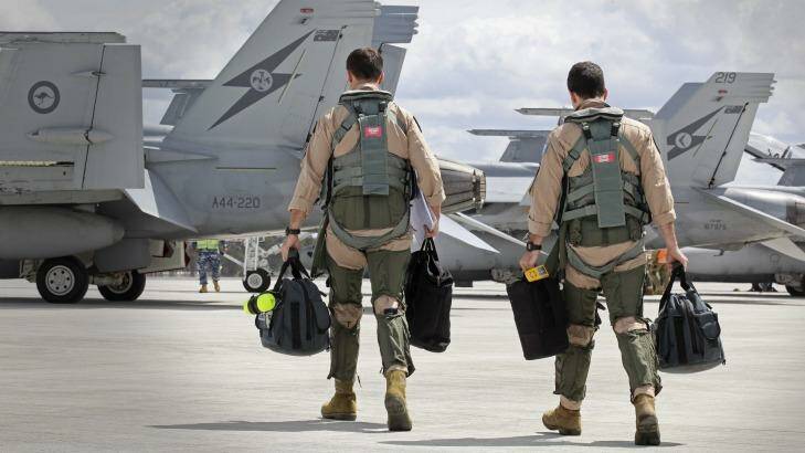 Super Hornet aircrew head to their aircraft in preparation for their departure.