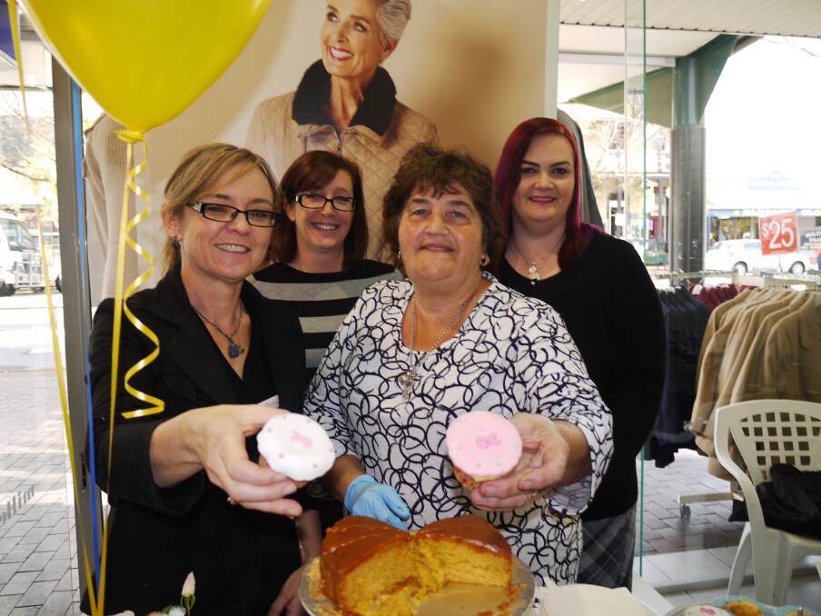 Margaret Langman (second from right) helped put food on the table at Australia's Biggest Morning Tea at Millers in Dubbo's Macquarie Street on Thursday. She is pictured with staff members (from left) Bernice Williams, Jo Russell and Donna Drayton.                    Photo: KIM BARTLEY