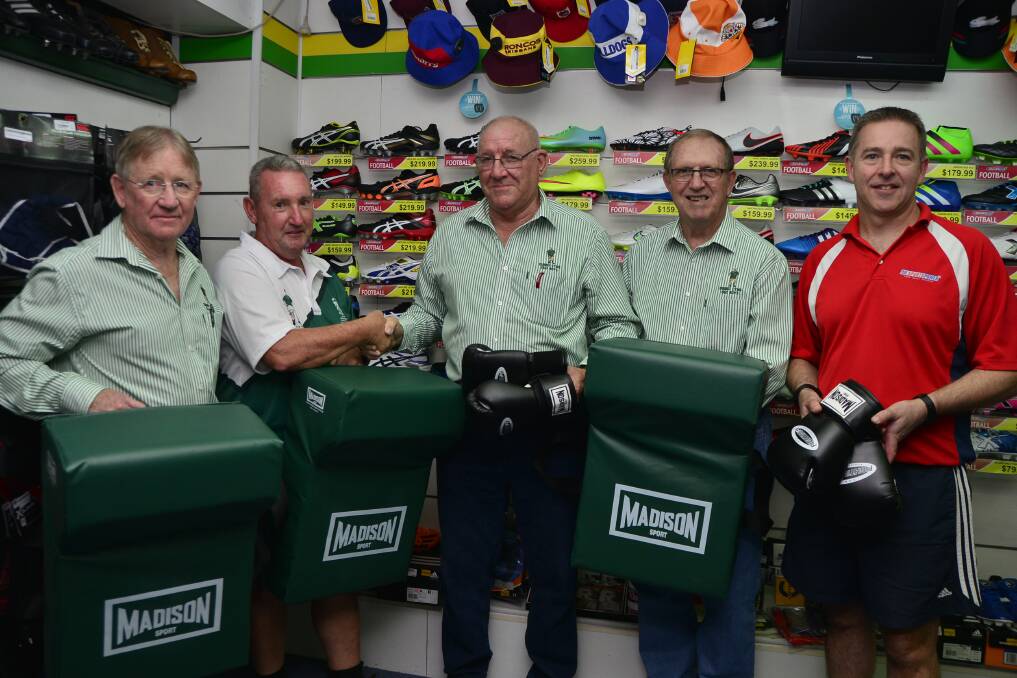 CYMS Rugby League football club representative Norman O'Neill (second from left) receives the new training gear from CYMS Old Boys Kel Brown, Bryan O'Sullivan and Barry O'Connor and Dubbo Sports Power's Anthony Barnes. 					   Photo: BELINDA SOOLE