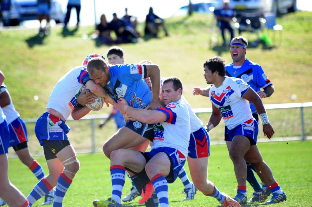 Tom Magann on the charge for Macquarie against Parkes last season. The Raiders have named their coaching staff for 2015 and are ramping up their preparations for a tilt at the Group 11 premiership.