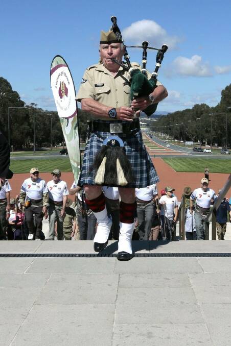 Piper leads walk: Bag piper Iain Townsley leads walkers from the Wandering Warriors down ANZAC parade in Canberra as they complete their Brisbane to Canberra challenge.  Photo: Jeffrey Chan