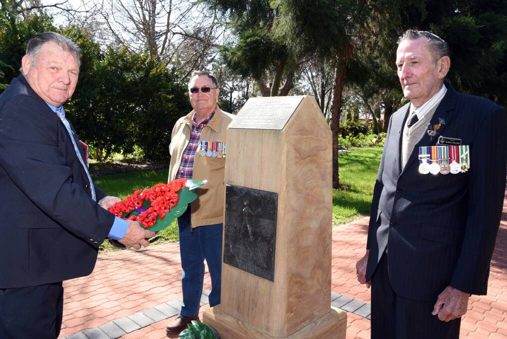 Bert Eade lays a wreath as Allan Russell and Mark Collins watch on. The three were at Victoria Park on Tuesday to pay their respects for Vietnam Veterans' Day.  
												Photo: BELINDA SOOLE