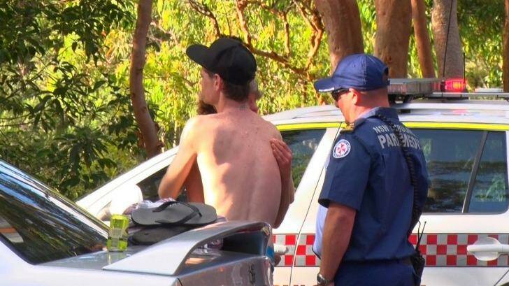 A relative of the 23-year-old man is comforted in the car park at Somersby Falls. Photo: Top Notch Video