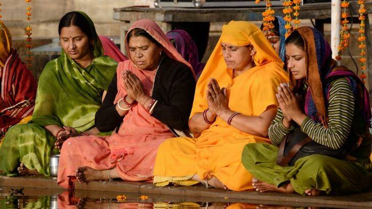 Women perform puja - ritual ceremony at holy Pushkar Sarovar lake. Photo: iStock