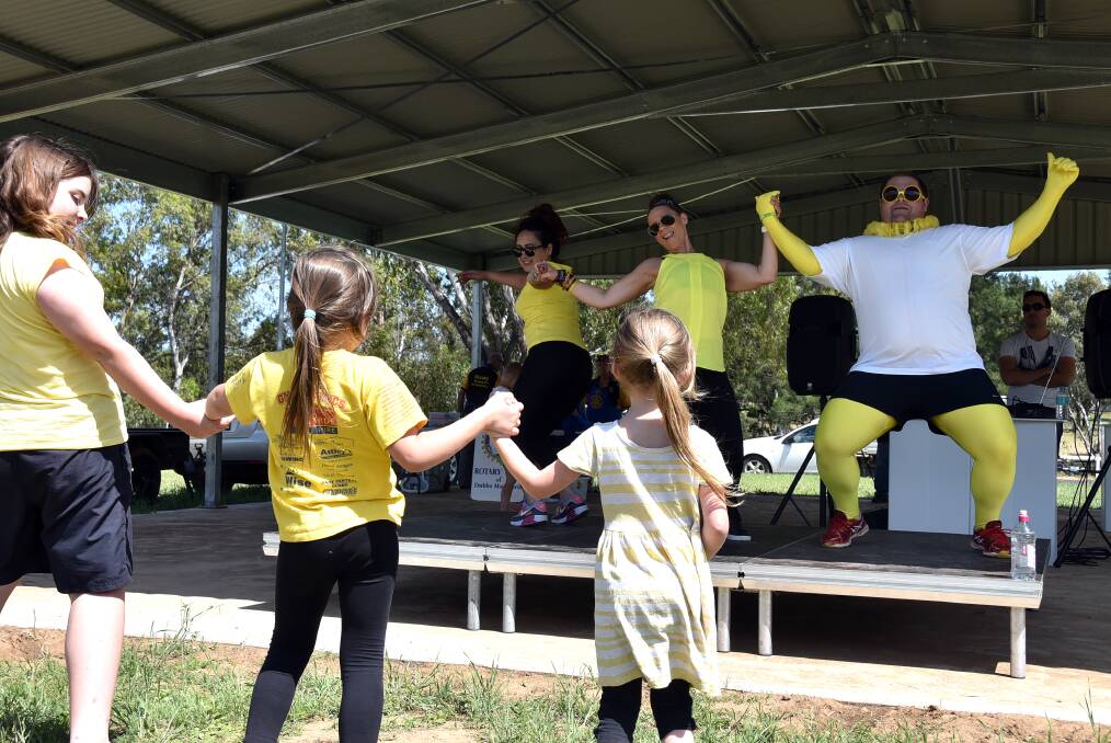 Dance the Battle Together organisers Juelz Jarry and Tracy Hanna are joined on stage by Jason Dearmer as they lead some enthusiastic participants in a zumba session at the event held to support women with depression. Photo: KATHRYN O'SULLIVAN