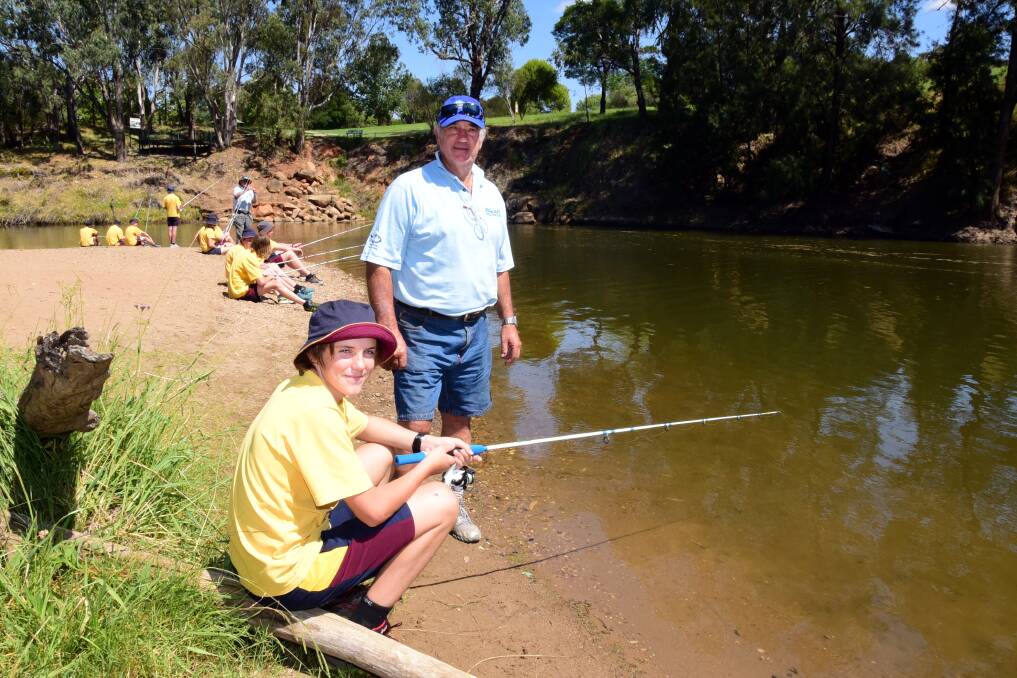 St John's student Jack Brown with Fishcare volunteer Charlie Haynes on the Macquarie River. 			         Photo: BELINDA SOOLE