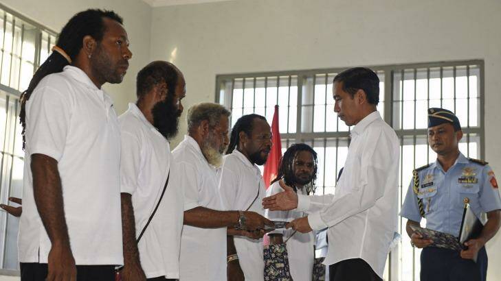 Indonesia's President Joko Widodo (right) hands over official pardons to five Papuan political prisoners belonging to the Free Papua Movement at a jail in Jayapura in May 2015. Photo: Antara Foto