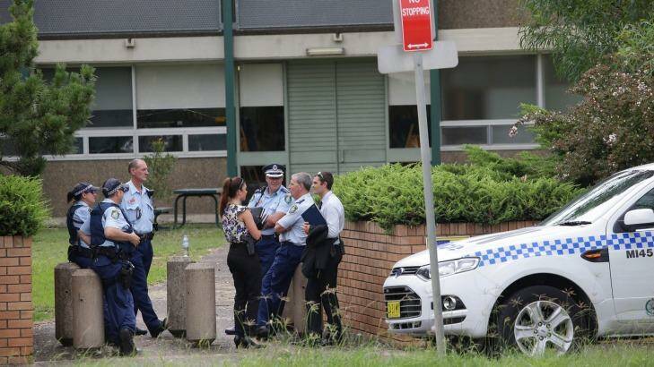 Police gather outside Woolooware High School, which also received a bomb threat. Photo: John Veage