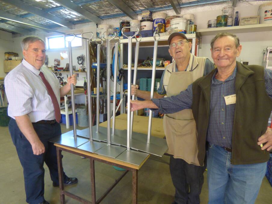 Rotarian and Michael Egan Memorial Book Fair co-ordinator Peter Bartley and Bob Boys and Colin Darlington from the Dubbo Community Men s Shed with the new book category sign stands. 	Photo: CONTRIBUTED