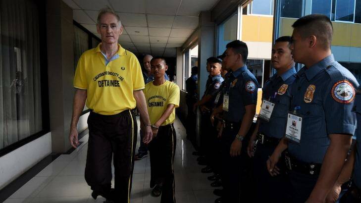 Peter Scully (left) arrives at the Cagayan De Oro court handcuffed to another inmate on his first day of his trial. Photo: Kate Geraghty