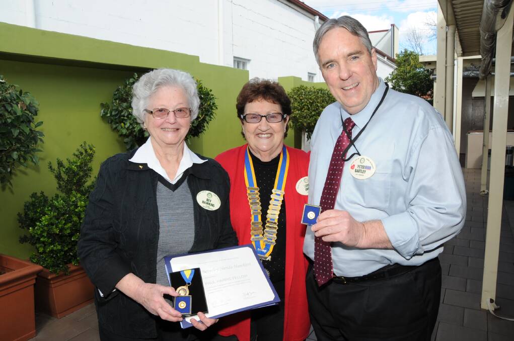 Rotary Club of Dubbo Macquarie president Lorna Breeze (centre) presents honours to club members Bev Hawkins and Peter Bartley.