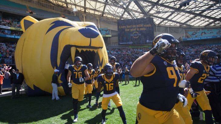 Cal players run onto the field at Sydney's ANZ Stadium for the first game of American college football played in Australia. Photo: Fiona Morris