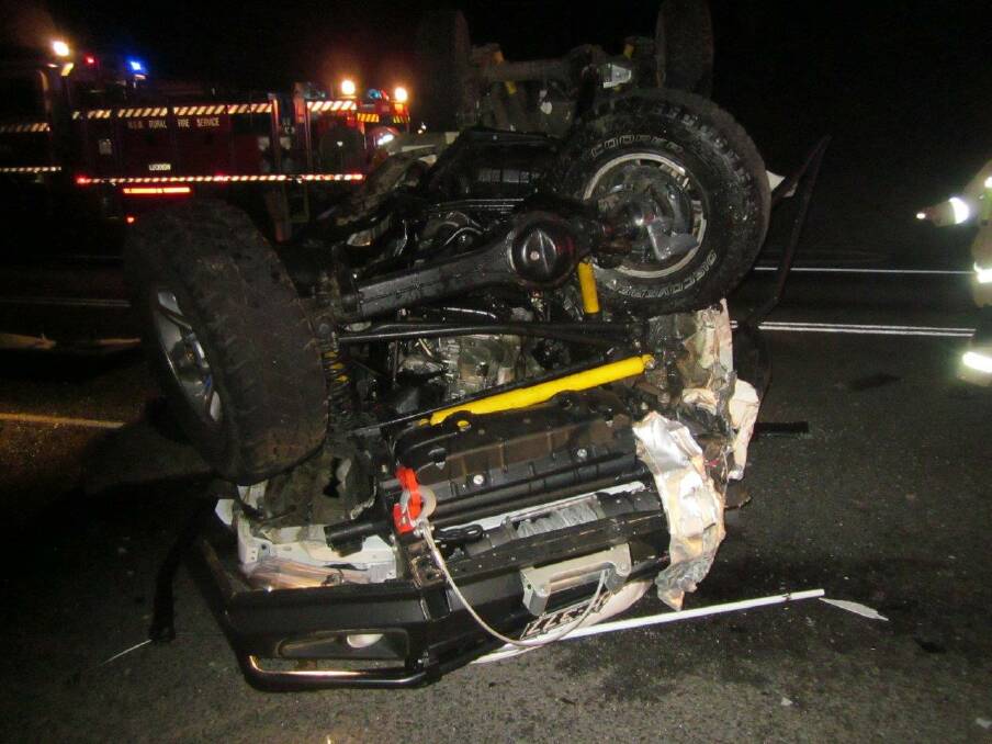 The wreckage of the white utility allegedly driven by Orange man Grant Robert Hughes on July 28, 2015.