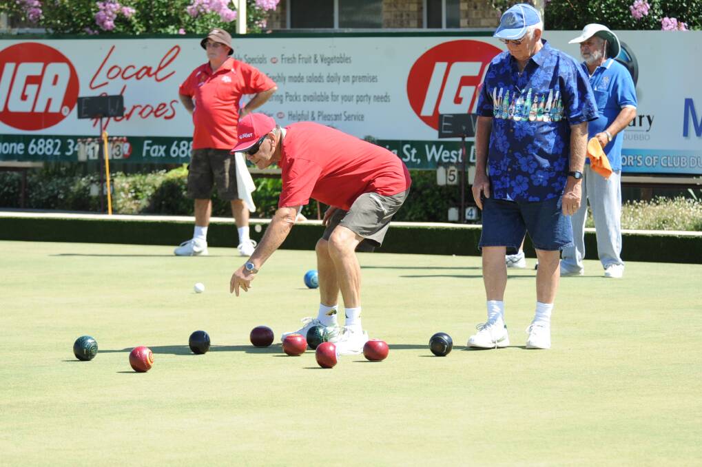 Bill Knight and Brian Jones check out the lay of the bowls at the close of an end.	Photos: CHERYL BURKE