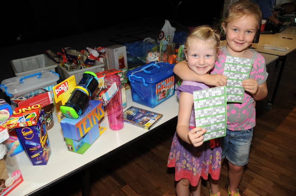 Lara and Emilie Hughes with some of the prizes that could have been won at Kid's Bingo. Photo: HANNAH SOOLE