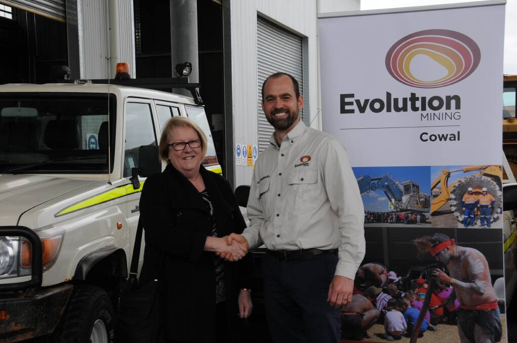 TAFE Western Institute director Kate Baxter accepts the keys to one of the donated vehicles from Evolution Mining senior social responsibility advisor Elliot Willemsen-Bell. 											     Photo: JENNIFER HOAR