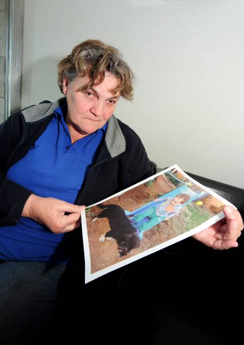 Rhonda Dorin with a photo of her grandson Jaida-David and their dog Scruff, who was bashed to death earlier this month.			         Photo: LOUISE DONGES.