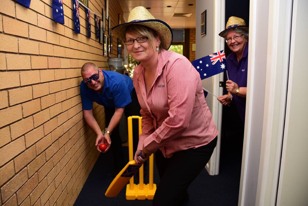 Rodney Ney (wicket-keeper), Kerry Moore (batting) and Sharon Balmer will celebrate Australia Day at Work this Friday. Photo: BELINDA SOOLE