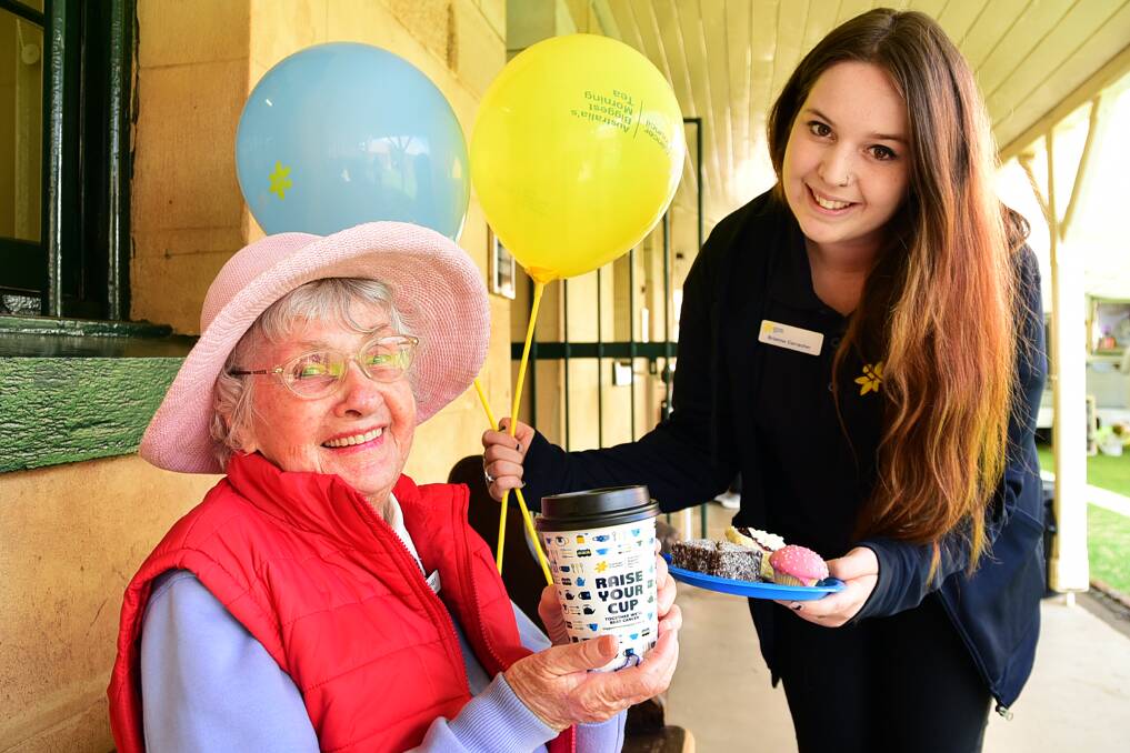 Dubbo cancer survivor Flo Ashby is served morning tea by Cancer Council NSW events co-ordinator Brianna Carracher at the public launch in Dubbo of Australia's Biggest Morning Tea. Photo: BELINDA SOOLE