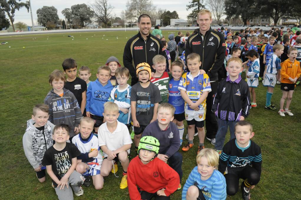 FANCLUB : At back left, Penrith Panthers players,Jamie Soward and Peter Wallace with some of kids that turned up for the junior rugby league training clinic, held at the Bathurst Sportsground. 	Photo: CHRIS SEABROOK