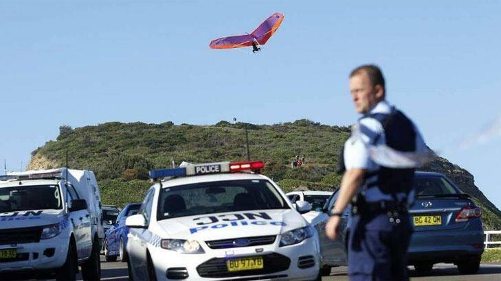 Other thrillseekers continue to hang-glide near the scene of a fatal crash in Newcastle on Sunday.  Photo: Max Mason-Hubers