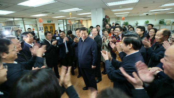 Workers applaud as Chinese President Xi Jinping talks with staff at the People's Daily in February. Photo: Xinhua/AP