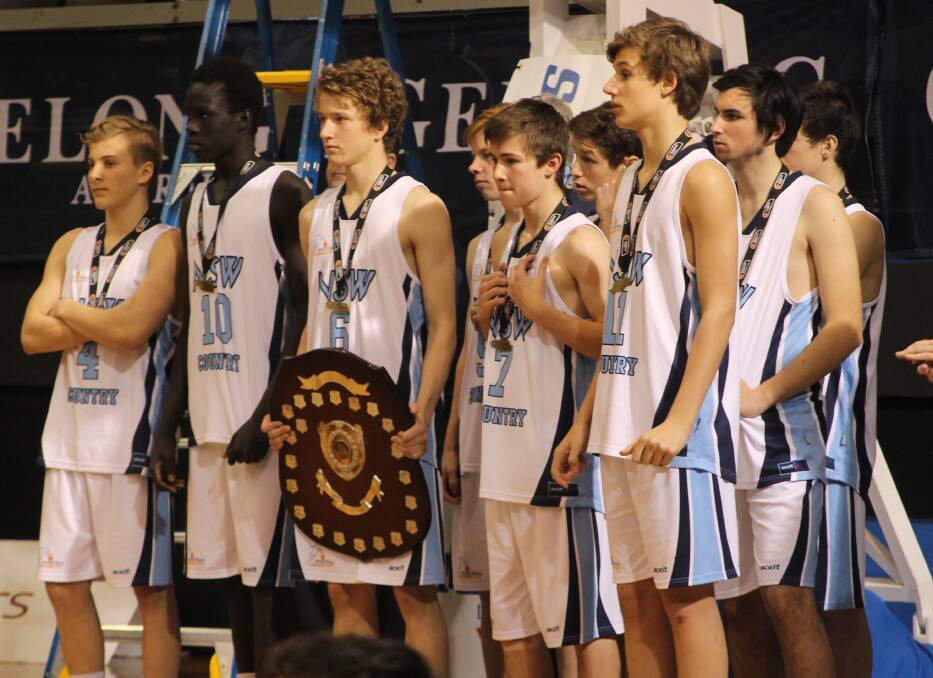 Dubbo's Will Howell (centre) with the trophy after leading NSW Country to the under-16s National Championships title.