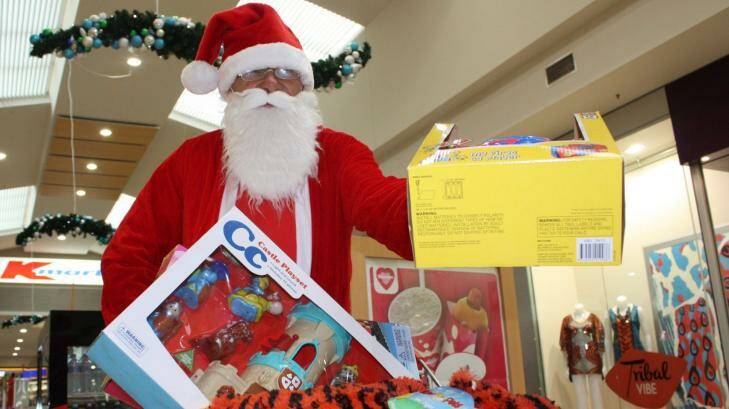 THAT TIME OF YEAR AGAIN?: Santa at Salamander Shopping Centre. Photo: Stephen Wark