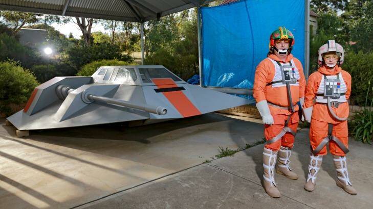 <i>Star Wars</i> fans Mark and Nancy Dickson with the full-sized snowspeeder Mark built in his garage in Eden Park, outside Melbourne. Photo: Wayne Taylor