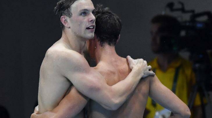 Kyle Chalmers with Cameron McEvoy after winning gold in the men's 100-metre freestyle final .  Photo: Joe Armao