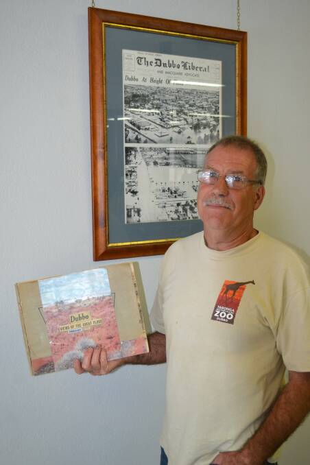 Rod Brown, with his dad's book of the 1955 Dubbo flood. 			  Photo: ORLANDER RUMING