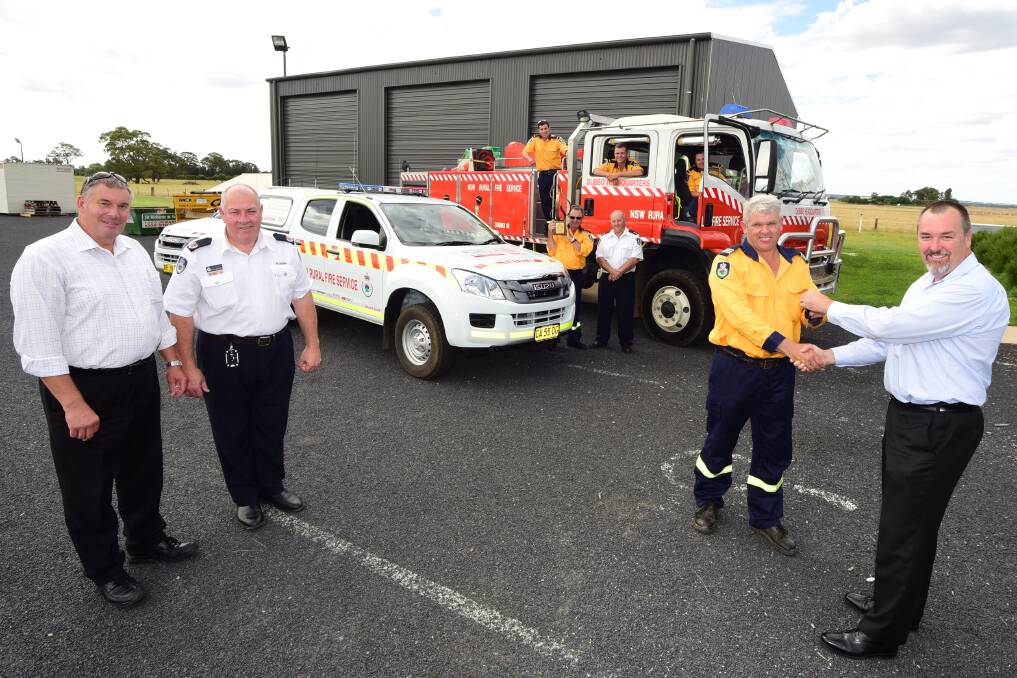 Gilbert & Roach Huntington Isuzu representative Glenn Jewell presents Orana composite team leader Craig Walters with the keys to the newest addition for Orana. Watching on are Rob Butcher and RFS assistant commissioner Bruce McDonald (far left), Jason Conn, Brad O'Leary and Joe Cooper (fire truck) and Peter Conn and Orana RFS team leader Lyndon Wieland. Tim Conn absent from photo. Photo: BELINDA SOOLE