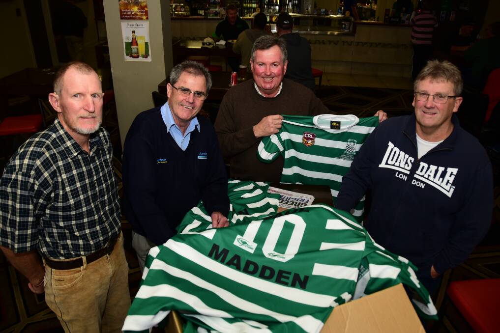 1975 CYMS players Col Parkes, Rick O'Dea, Andrew Hamblin and Paul Madden with the special jerseys the modern Fishies will wear on Saturday. 	Photo: BELINDA SOOLE