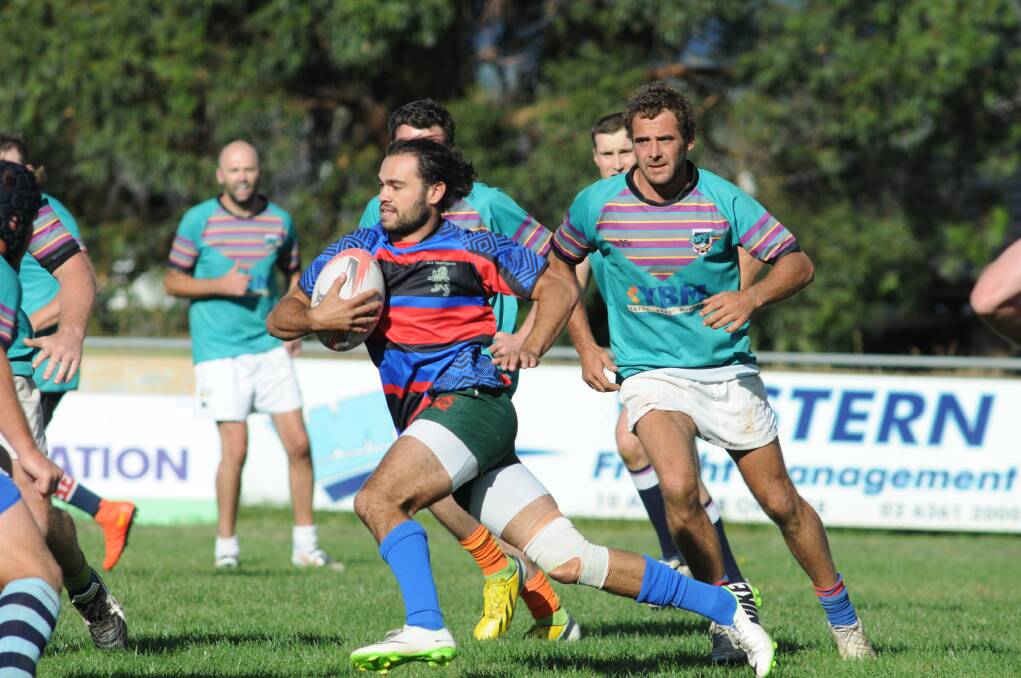 RIGHT: Terry Brown, for the Jack Blunt Legends, runs at the YBM Chargers' defence.  
Photo: JUDE KEOGH