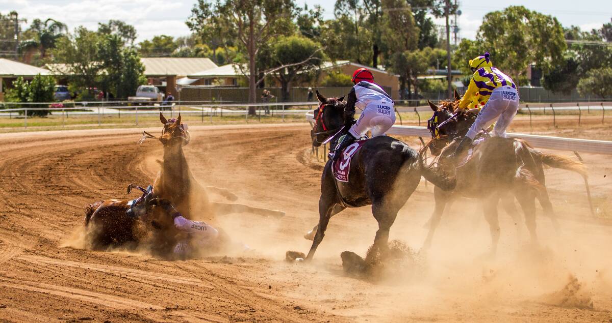 Dust flies as Royal Society and Catherine Newcombe fall shortly after winning at Nyngan on Saturday. 			  Photo: SIMON THOMPSON (www.racingphotography.com.au)