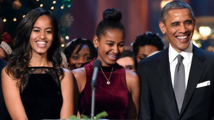 Malia and Sasha Obama with their father in Washington at Christmas,  2014. Photo: Theo Wargo