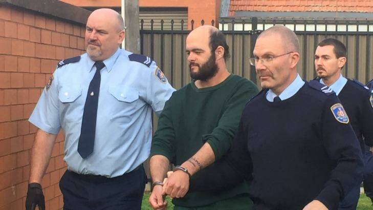 Marcus Stanford is escorted into Leeton court on Tuesday. Photo: Emma Partridge