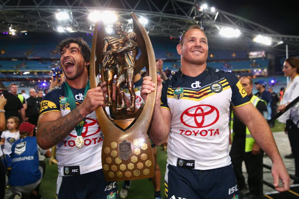 There were few people at Dubbo more pleased to see Cowboys co-captains Johnathan Thurston and Matt Scott lifting the trophy than former Cowboy Wayne Sing. 	Photo: GETTY IMAGES