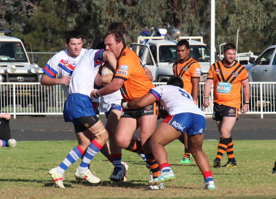 Nyngan s Brian Perry takes on the Parkes defence earlier this season. Nyngan and Macquarie meet in today s top of the table match. 	Photo: Stacey Wright