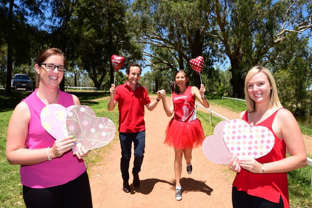 Dubbo parkrun committee members Tim Morris and Miriam Tan (centre) get into the spirit of Valentine's Day with the support of committee member Lynn Pinkerton (left) and Marathon Health team member Sian Draffin (right) ahead of a Valentine's Day themed parkrun on Saturday.  
Photo: BELINDA SOOLE