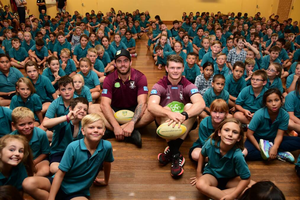 Manly Sea Eagles Josh Starling and Hugh Pratt with students from Orana Heights Primary School on Tuesday.	Photo: BELINDA SOOLE