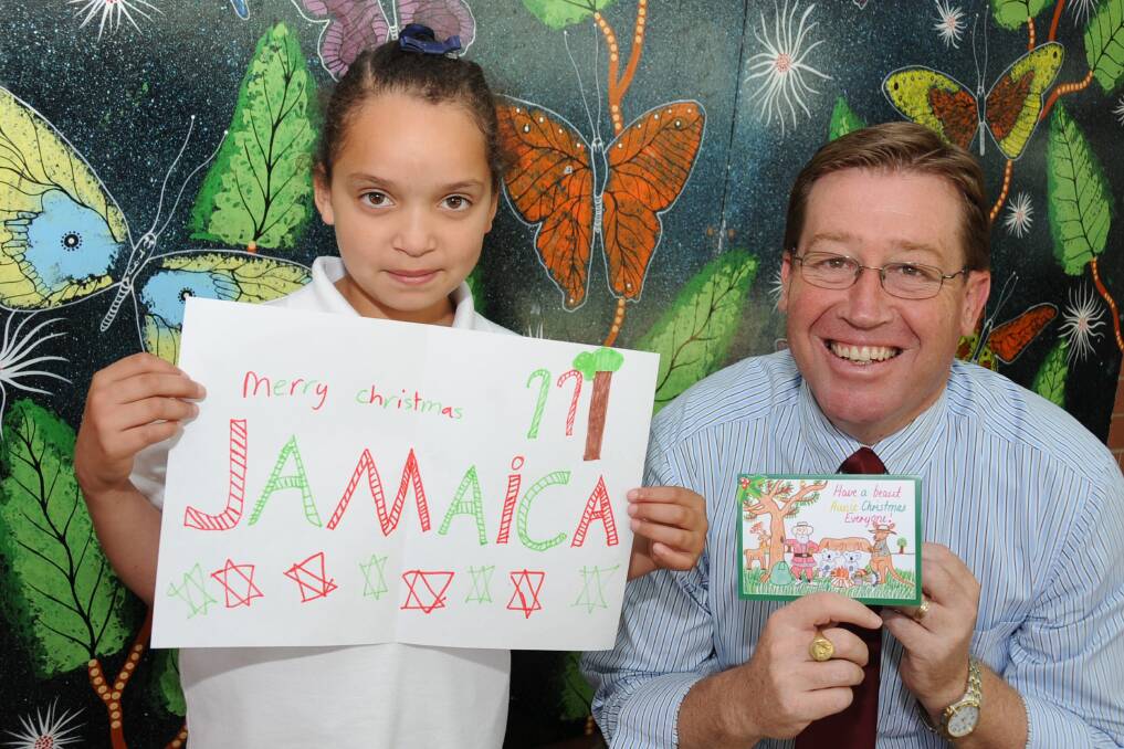Jamaica Newman with her Christmas card design and Troy Grant with last year's card.