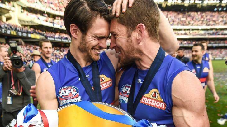 Wonderdogs: Easton Wood and Dale Morris celebrate their AFL grand final win with the cup. Photo: Justin McManus