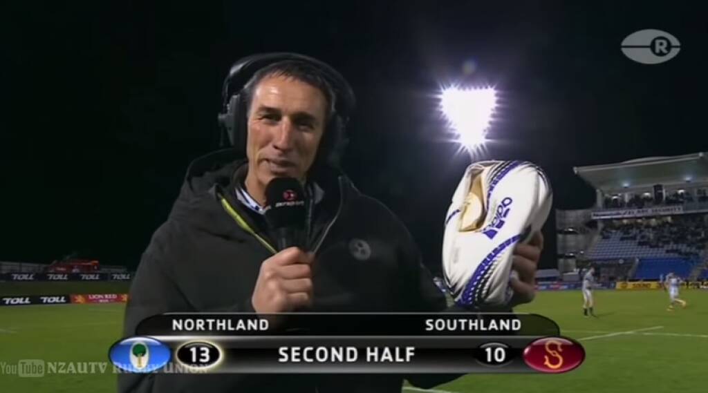 Deflategate: Rugby commentator Ian Jones holds the popped rugby ball that Southland flanker Tim Boys scored with Photo: YouTube/NZAUTV