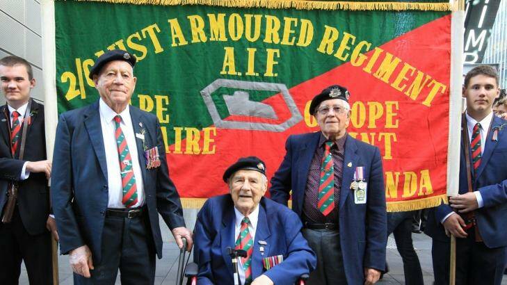 Russ Green, Doug Spinney, and Fred Chivers have donated their regimental banner and, on Monday, marched under it for the last time Photo: Wolter Peeters