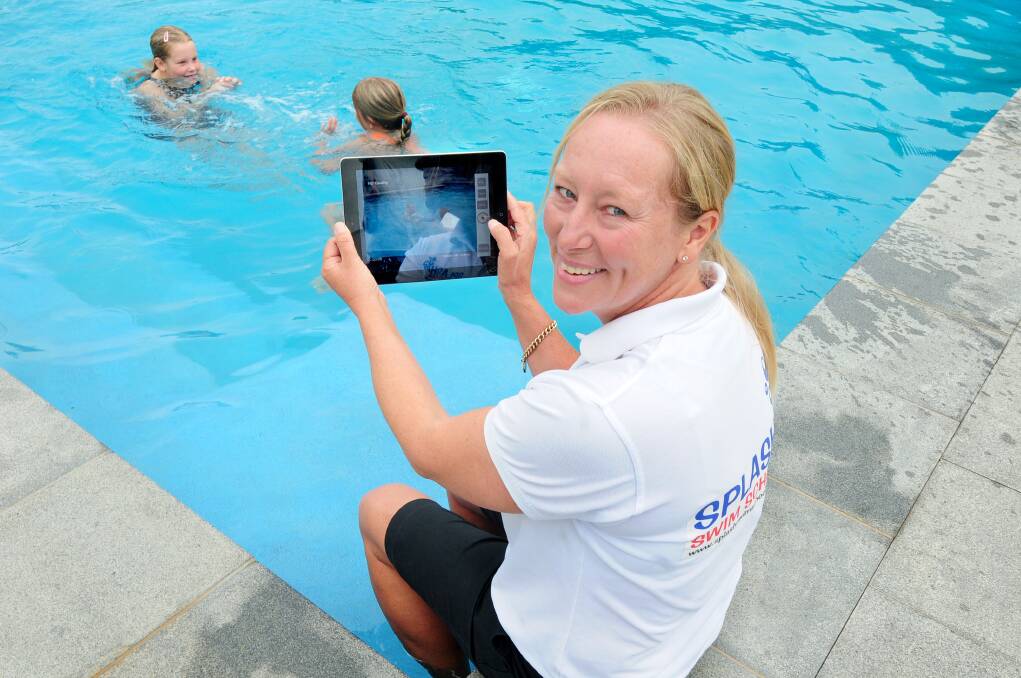 Businesswoman and academic Cath Osborne uses her iPad to record and then upload swimming lessons at her home at Eulomogo, enjoying the advantages of the National Broadband Network (NBN). 							         Photo: LOUISE DONGES
