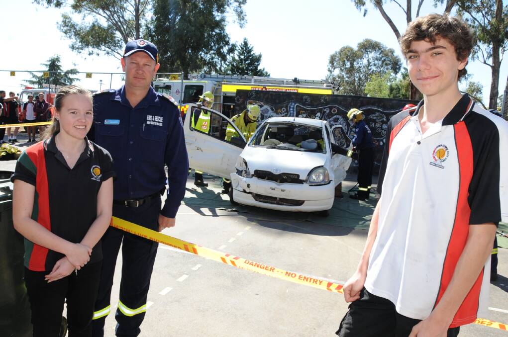 Dubbo College Delroy Campus students Jessica Wyatt and Matthew Costa with Steve Gilbert of NSW Fire and Rescue. 	Photo: BELINDA SOOLE